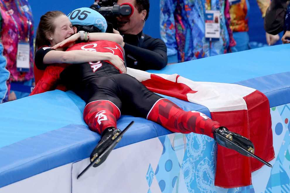 Золотой медалист Чарльз Хамельн из Канады обнимает свою невесту после победы в финале по шорт-треку на 1500 м