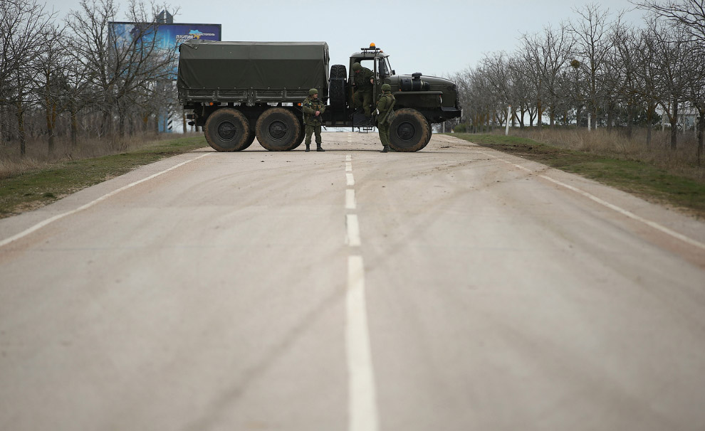 Солдаты блокируют дорогу, ведущую к аэропорту Бабек в районе Севастополя, по-видимому, занятый российскими войсками